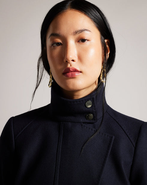 ICOMBIS-Outerwear-The Short Funnel Neck Coat is perfect for colder days, offering maximum warmth and comfort. Its unique design is stylish yet functional, keeping you cozy and looking good during the fall and winter seasons. Add this versatile coat to your wardrobe for a sleek and sophisticated look while staying warm and protected from the elements.- Ted Baker Romania